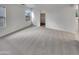 Bright main bedroom with large windows, neutral carpeting, and closet access at 7720 W Pipestone Pl, Phoenix, AZ 85035