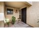 Exterior home entrance with decorative metal door, small window, and textured facade at 8344 N 21St Dr # I105, Phoenix, AZ 85021