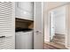 Stacked washer and dryer inside of louvered closet adjacent to the bedroom at 8344 N 21St Dr # I105, Phoenix, AZ 85021