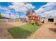 Expansive backyard featuring fun play structure on artificial turf with a trampoline and more at 8531 N 37Th Ave, Phoenix, AZ 85051