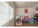 Convenient laundry space equipped with washer, natural light and toys for added play at 8531 N 37Th Ave, Phoenix, AZ 85051