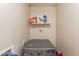 Functional laundry area with appliances, shelving, and room for cleaning supplies and organizing tasks at 8531 N 37Th Ave, Phoenix, AZ 85051
