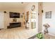 Open-concept living area features tile flooring, neutral tones, and an entertainment center at 8531 N 37Th Ave, Phoenix, AZ 85051