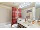 Bathroom with a bathtub, shower and vanity featuring dark cabinets and a large mirror at 8700 E Mountain View Rd # 2058, Scottsdale, AZ 85258