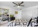 Bedroom with a large window, fan, mirror and black and white pattern bedspread at 8700 E Mountain View Rd # 2058, Scottsdale, AZ 85258