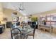 Spacious dining area with vaulted ceilings, a fireplace, and views to the outside balcony at 8700 E Mountain View Rd # 2058, Scottsdale, AZ 85258