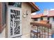 Inviting condo entrance with decorative door, 'Welcome' sign, and small table with chairs at 8700 E Mountain View Rd # 2058, Scottsdale, AZ 85258