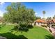 Charming home featuring a lush green lawn and mature shade tree for outdoor enjoyment at 8700 E Mountain View Rd # 2058, Scottsdale, AZ 85258