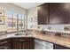 Functional kitchen with stainless steel sink, granite countertops, and wood cabinets at 8700 E Mountain View Rd # 2058, Scottsdale, AZ 85258