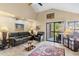 Comfortable living room featuring leather furniture and a sliding glass door with natural light at 8700 E Mountain View Rd # 2058, Scottsdale, AZ 85258
