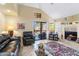 Comfortable living area with fireplace, vaulted ceilings, and access to the balcony at 8700 E Mountain View Rd # 2058, Scottsdale, AZ 85258