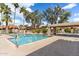 Relaxing community pool area with lounge chairs and lush landscaping surrounded by palm trees at 8700 E Mountain View Rd # 2058, Scottsdale, AZ 85258