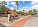 Community entrance with 'Sun Canyon on McCormick Ranch' sign, palm trees, and blue sky at 8700 E Mountain View Rd # 2058, Scottsdale, AZ 85258