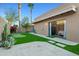 Charming backyard featuring a putting green, desert landscaping, trees, and a paver patio at 9088 E Winchcomb Dr, Scottsdale, AZ 85260