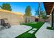 Enclosed yard with desert landscaping, putting green, trees, and paver patio at 9088 E Winchcomb Dr, Scottsdale, AZ 85260