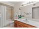Bright bathroom featuring a single vanity, a large mirror, and a shower-tub combo at 9088 E Winchcomb Dr, Scottsdale, AZ 85260