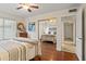 Cozy bedroom features hardwood floors, comfortable bed, and mirrored closet doors at 9088 E Winchcomb Dr, Scottsdale, AZ 85260