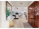 Welcoming foyer with tiled flooring, wood door, leading to the living area and modern kitchen at 9088 E Winchcomb Dr, Scottsdale, AZ 85260