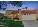 Charming home with red tile roof, desert landscaping, two car garage, and inviting front porch at 9088 E Winchcomb Dr, Scottsdale, AZ 85260