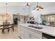 Open-concept kitchen with an island, stainless steel appliances, and seamless flow to the living area at 9088 E Winchcomb Dr, Scottsdale, AZ 85260
