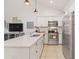 Bright, updated kitchen showcases stainless steel appliances and a large island with ample counter space at 9088 E Winchcomb Dr, Scottsdale, AZ 85260