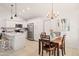 Bright kitchen features white cabinets, stainless appliances, and an adjacent dining area with a stylish chandelier at 9088 E Winchcomb Dr, Scottsdale, AZ 85260