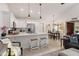 Bright kitchen features white cabinets, quartz countertops, stainless appliances, and breakfast bar seating at 9088 E Winchcomb Dr, Scottsdale, AZ 85260