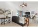 Spacious living room with vaulted ceiling, dark sofa, neutral tile, and stylish decor at 9088 E Winchcomb Dr, Scottsdale, AZ 85260