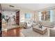 Bright living room featuring hardwood floors, contemporary furnishings, and a seamless transition to the kitchen at 9088 E Winchcomb Dr, Scottsdale, AZ 85260