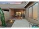 Inviting patio with tile flooring, gas grill, dining set, and view to interior through sliding glass doors at 9088 E Winchcomb Dr, Scottsdale, AZ 85260