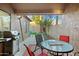 Cozy outdoor patio with grill, table, chairs, and view of a well-kept yard, great for relaxation at 9088 E Winchcomb Dr, Scottsdale, AZ 85260