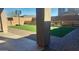 View of the backyard with a basketball hoop, artificial turf, and a paver patio at 9207 W Sells Dr, Phoenix, AZ 85037