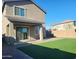 Backyard with artificial grass, covered patio, and easy access to indoor living spaces at 9207 W Sells Dr, Phoenix, AZ 85037