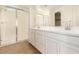 Bright bathroom featuring dual sinks, a walk-in shower, and elegant fixtures at 9207 W Sells Dr, Phoenix, AZ 85037