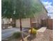 Exterior shot of the home with landscaped yard and trees, showing a two-car garage and driveway at 9207 W Sells Dr, Phoenix, AZ 85037