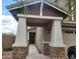 Covered front porch with stone accents and decorative pillars offering a welcoming entrance at 9207 W Sells Dr, Phoenix, AZ 85037