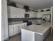 Bright kitchen features white cabinetry, stainless steel appliances, and a large center island at 9207 W Sells Dr, Phoenix, AZ 85037