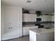 Bright kitchen features white cabinetry, stainless steel appliances, and a large center island at 9207 W Sells Dr, Phoenix, AZ 85037