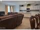 Open-concept living area with a view of the modern kitchen and comfortable seating at 9207 W Sells Dr, Phoenix, AZ 85037
