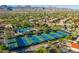 Expansive aerial view showcasing community amenities, including tennis courts, pool and lush desert landscaping with mountain views at 9475 N 115Th Pl, Scottsdale, AZ 85259