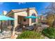 Inviting back patio featuring a dining table, grill, and comfortable seating under a turquoise umbrella, perfect for outdoor entertaining at 9475 N 115Th Pl, Scottsdale, AZ 85259