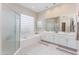 Bright primary bathroom with double sinks, glass shower, and soaking tub with natural light at 9475 N 115Th Pl, Scottsdale, AZ 85259
