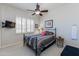Comfortable bedroom with a ceiling fan, shutters, and a mounted TV at 9475 N 115Th Pl, Scottsdale, AZ 85259