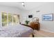 Bright bedroom with wooden dresser, natural light, and calm decor at 9475 N 115Th Pl, Scottsdale, AZ 85259
