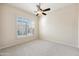 Well-lit bedroom featuring a ceiling fan and large window with shutters at 9475 N 115Th Pl, Scottsdale, AZ 85259