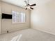 Neutral bedroom featuring a wall-mounted television and window with shutters at 9475 N 115Th Pl, Scottsdale, AZ 85259