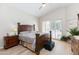 Spacious bedroom featuring a wooden bed frame, light-colored walls, and natural light from the windows at 9475 N 115Th Pl, Scottsdale, AZ 85259