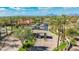 Welcoming gated community entrance lined with lush palm trees and beautiful desert landscaping under a bright, sunny sky at 9475 N 115Th Pl, Scottsdale, AZ 85259