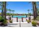 Beautiful community pool surrounded by lush palm trees, offering a serene and inviting space for relaxation and recreation at 9475 N 115Th Pl, Scottsdale, AZ 85259