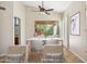 Staged dining room featuring a modern table, chairs, and hardwood floors at 9475 N 115Th Pl, Scottsdale, AZ 85259